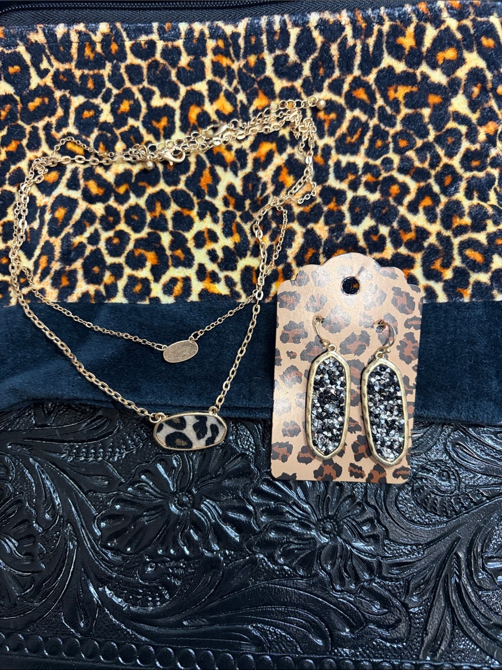 Velvet bag with gold tones necklace and earrings.